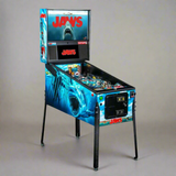 A Jaws pinball machine with a theme based on the Jaws movie, featuring a shark design and movie branding on the body and backglass.