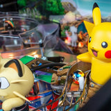 Pikachu figure in a pinball machine with a Pokémon logo.