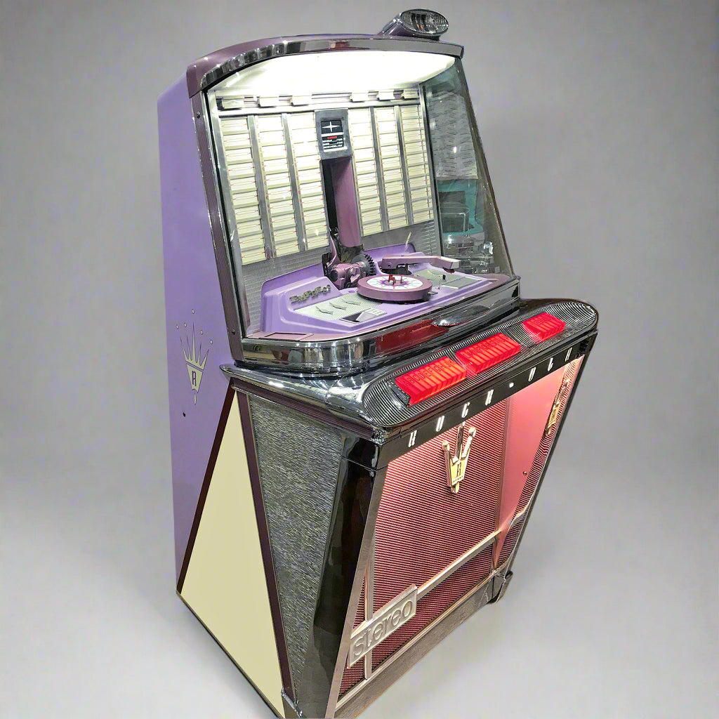 A restored Rock-Ola Empress 120 1496 vinyl jukebox with a purple, gray, and red color scheme, featuring a glass display, selection slots, and control buttons.