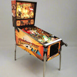 A restored 1993 Indiana Jones pinball machine by Williams with vibrant colorful artwork, lit up and ready for play.