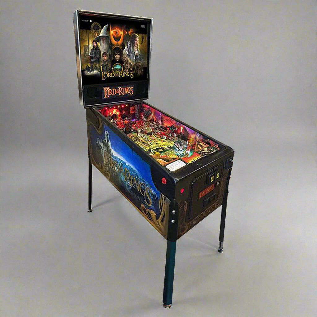 A restored 2003 Lord of The Rings Pinball Machine by Stern, featuring new playfield mirror rails and bright LED lighting, with cabinet artwork renewed.