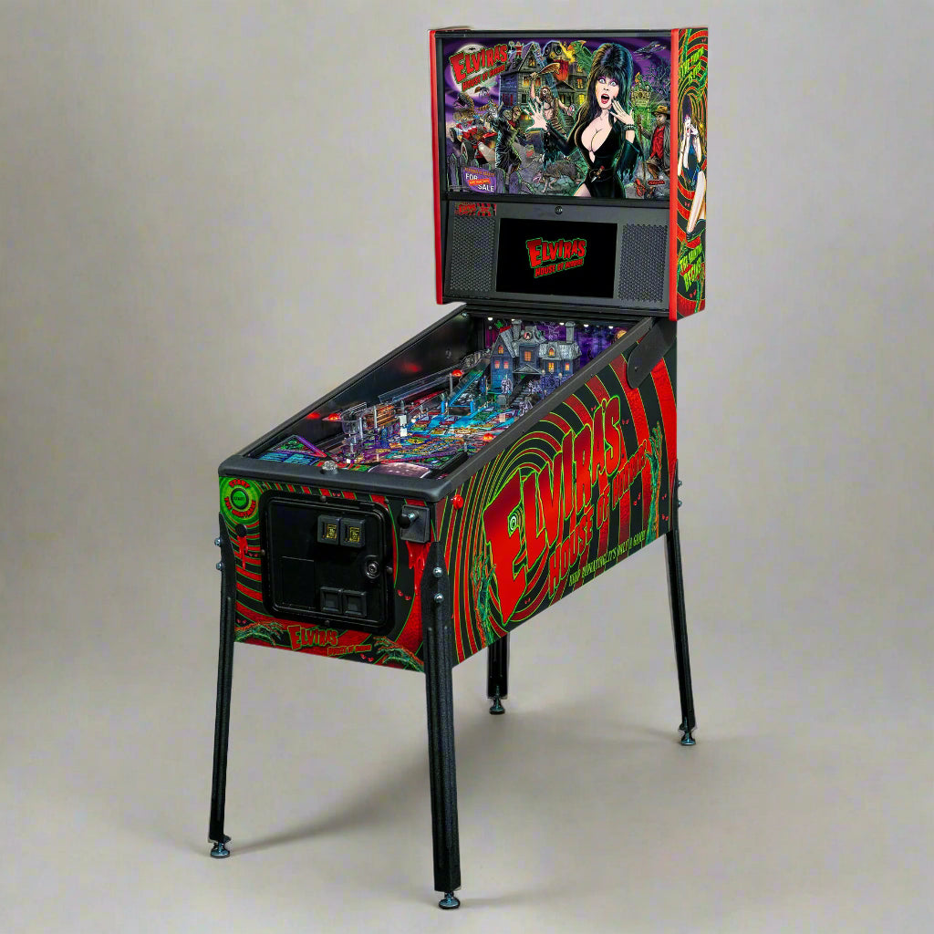 A colorful pinball machine featuring artwork with Elvira and movie-themed elements, indicating a horror movie universe setting for the game.